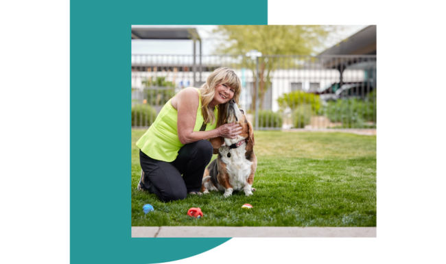 a woman kneeling down petting a dog