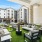 an outdoor lounge area with a pool and building in the background