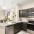 a kitchen with dark cabinets