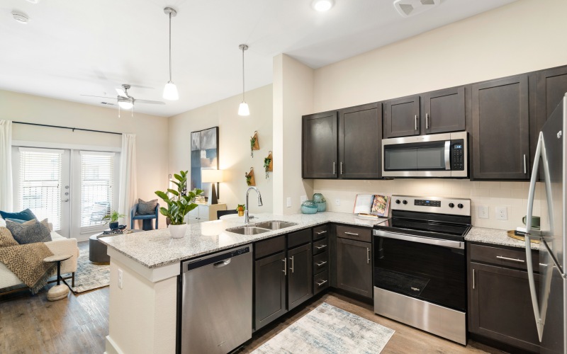 a kitchen with dark cabinets