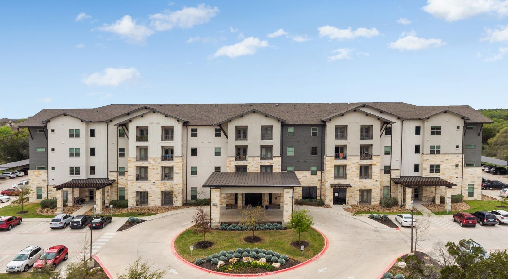 Settle into comfort at ArborView a building with cars parked in front