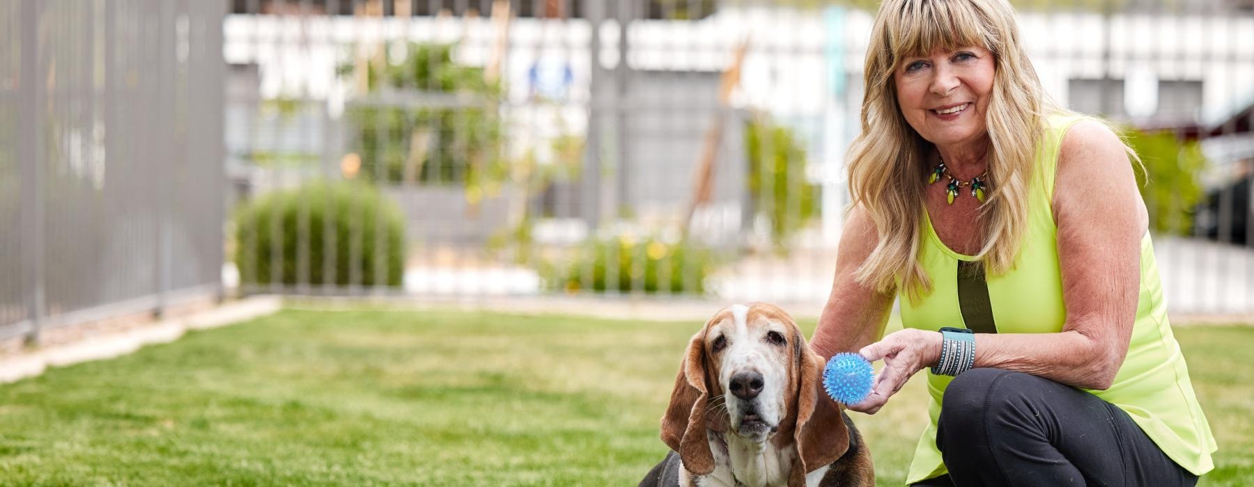 a woman sitting with a dog